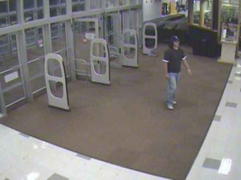 Surveillance photo of a pharmacy robbery at the South Regal Street ShopKo 9:42 p.m. Aug. 24, 2009. The robber is described as a white male in his 20s with dark stubble and approximately 6 feet, 3 inches tall. (Courtesy of Crime Stoppers)