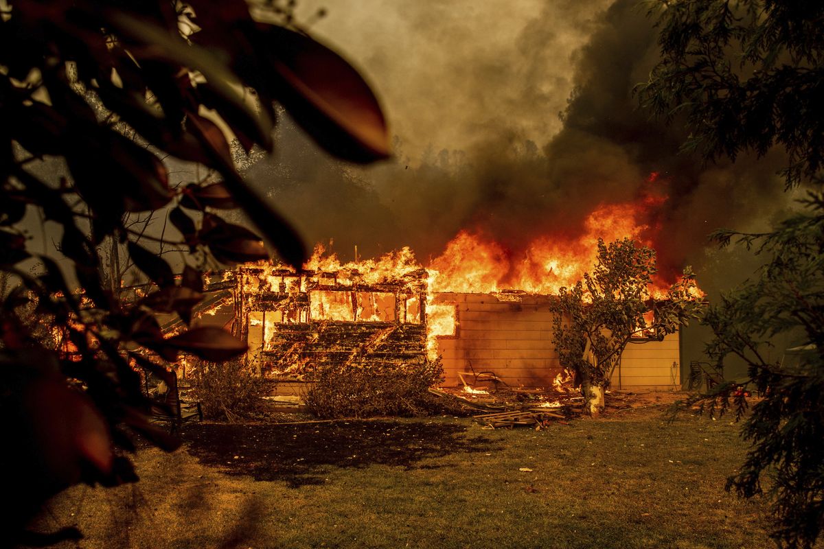 Flames consume a house near the Old Oregon Trail as the Fawn fire burns Thursday north of Redding in Shasta County, Calif.  (Ethan Swope)