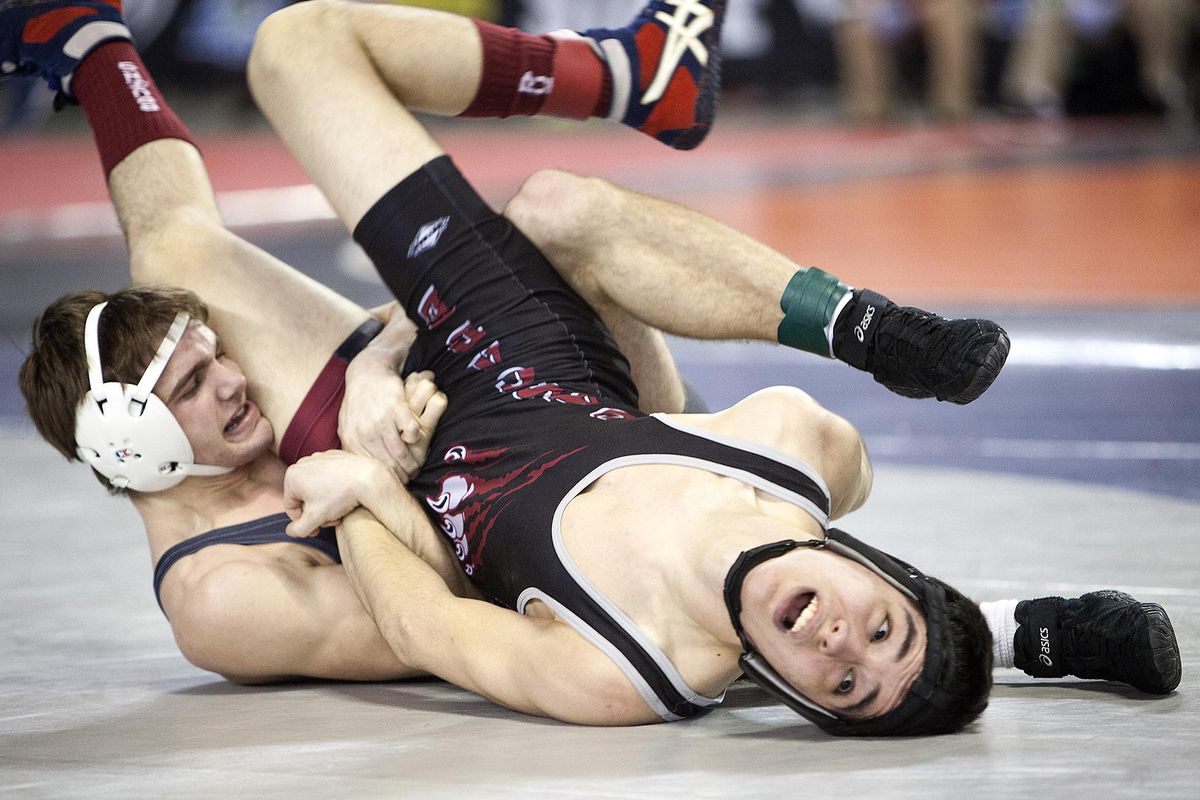 Central Valley’s Braedon Orrino, left, works to pin  Luke Lebeouf of Cascade (Everett) during the 4A opening round at 145 pounds. (Patrick Hagerty / Special to The Spokesman-Review)