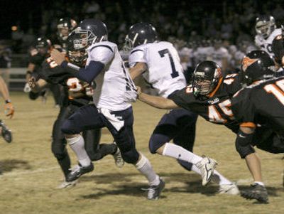 
Lake City QB Garren Hammons breaks free of Post Falls' Duane Carr (45) for a 14-yard gain in the second quarter. 
 (Bruce Twitchell Special to / The Spokesman-Review)