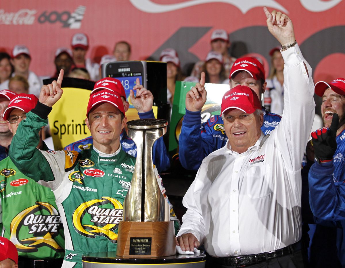 Kasey Kahne, left, and team owner Rick Hendrick, right, pose with first-place trophy. (Associated Press)