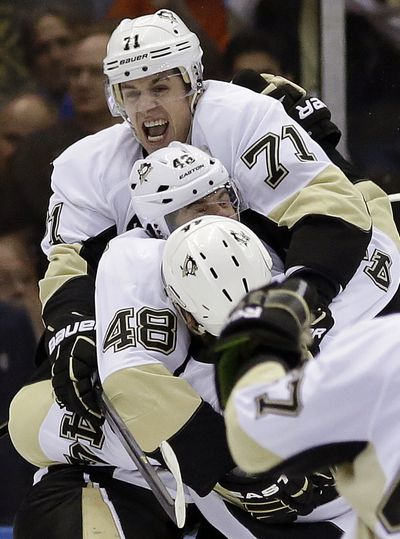 Penguins celebrate goal in overtime that eliminated the Islanders from playoffs. (Associated Press)
