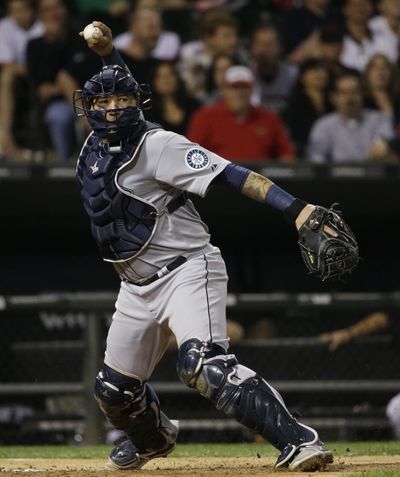 Mariners catcher Jesus Sucre throws to first base to complete a critical double play in the seventh. (Associated Press)
