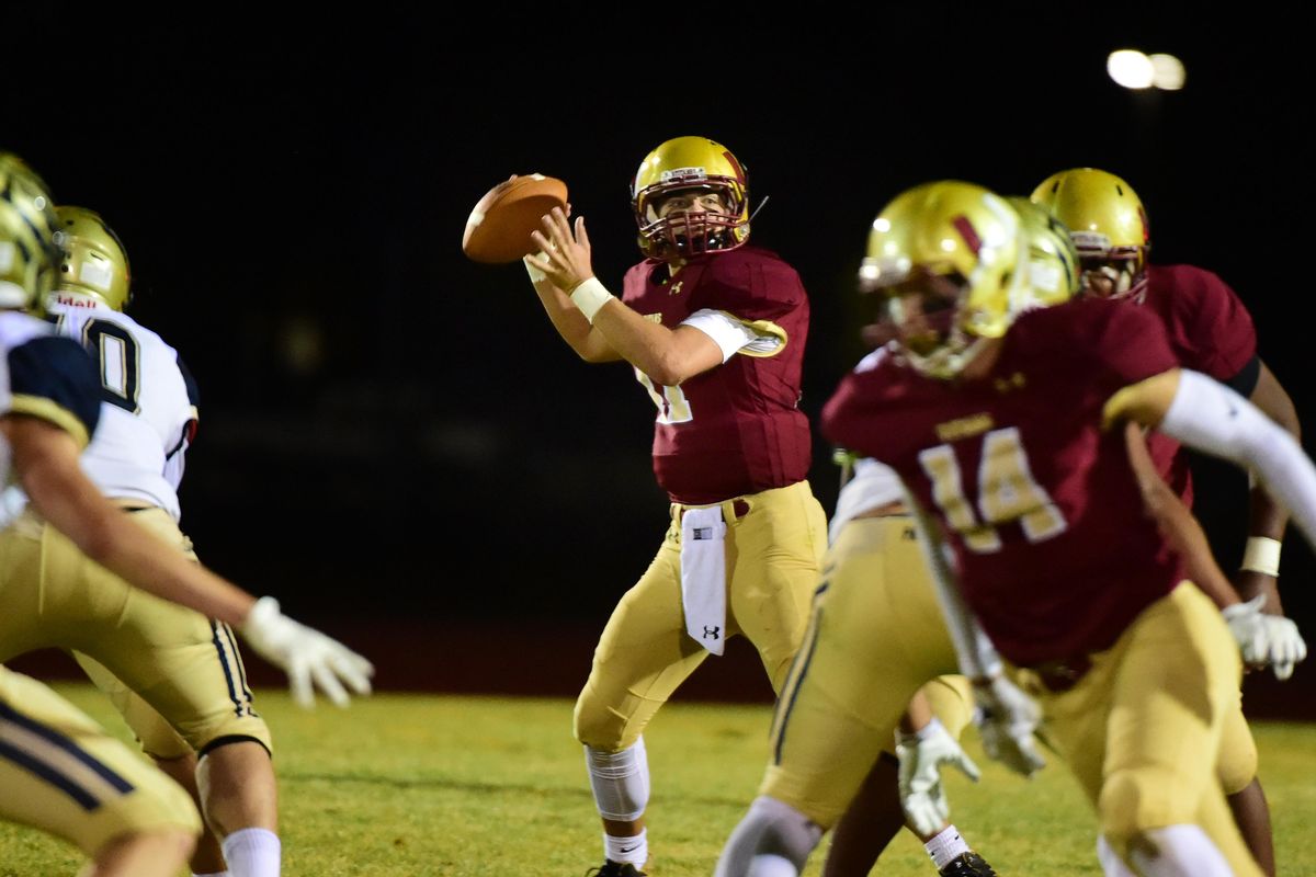 University quarterback Gavin Wolcott looks for a receiver downfield Friday, Sept. 28, 2018 during the Titans’ game against Mead at University High School. (Jesse Tinsley / The Spokesman-Review)