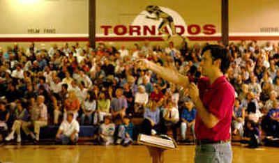 
Using a PowerPoint presentation, Mike Wright shares data he collected on the proposed Yelm, Wash., NASCAR site with an audience of around 800 who packed the high school gymnasium Monday evening for an information meeting sponsored by a group against the project.
 (Associated Press / The Spokesman-Review)