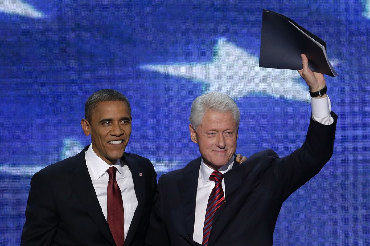 Former President Bill Clinton waves to the delegates as he stands with President Barack Obama after Clinton addressed the Democratic National Convention in Charlotte, N.C., on Wednesday, Sept. 5, 2012. (J. Applewhite / Associated Press)