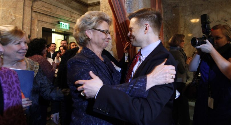 Gov. Chris Gregoire is embraced by Rep. Jamie Pedersen, D-Seattle, after the House voted to legalize gay marriage Wednesday in Olympia. Gregoire is likely to sign the bill next week; a date has not yet been set for the ceremonial signing, but a sizable crowd is expected. (Associated Press)