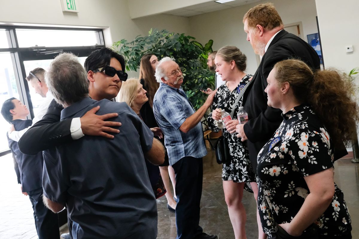 David Pancoast, wearing sunglasses, is embraced during a community gathering Saturday following a memorial service for brother Lucas Pancoast at the Colville Ag Trade Center in Colville. Lucas died July 20.  (Tyler Tjomsland/The Spokesman-Review)