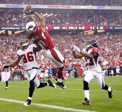 Arizona’s Larry Fitzgerald beats Lawyer Milloy, left, and Chris Houston for a touchdown.  (Associated Press / The Spokesman-Review)