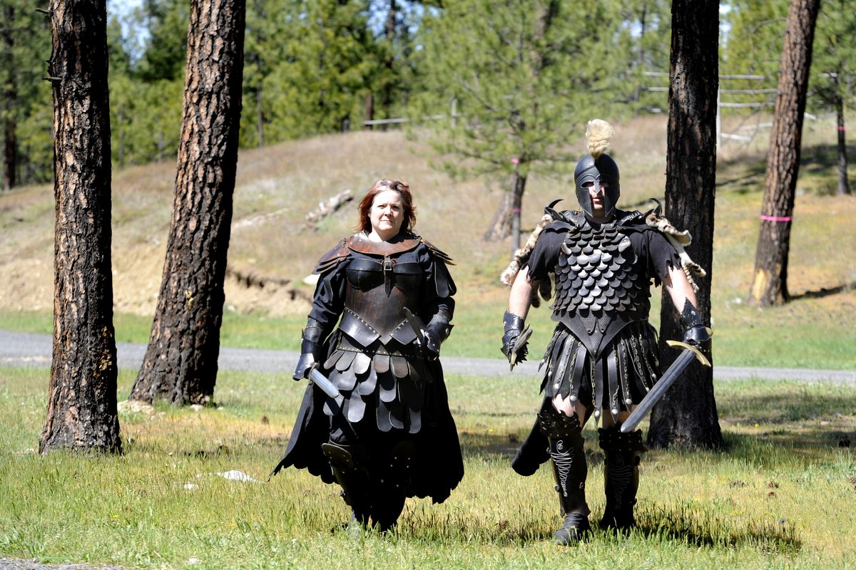 Tara and Alex Mickschl wear some of their handmade costumes in the woods of Riverside State Park on Wednesday. The Mickschls were extras in the movie “Knights of Badassdom,” which was filmed in the park in 2010. (JESSE TINLSEY)