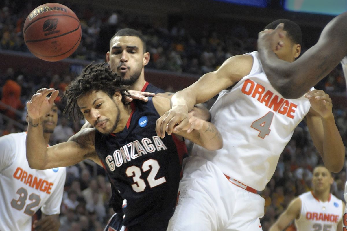 Gonzaga’s Steven Gray has the ball knocked away from him by Syracuse’s Wes Johnson during their second-round game in Buffalo, N.Y. (PHOTOS BY CHRISTOPHER ANDERSON)