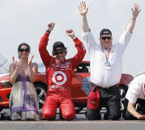 Dario Franchitti celebrates at the Indianapolis Motor Speedway start/finish line with his wife, Ashley Judd, and car owner Chip Ganassi. (Associated Press)