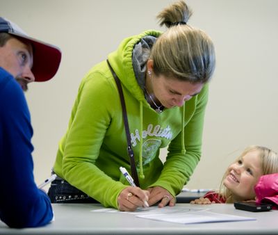 Addison Havel, age 4 of Newman Lake, Wash., beams as her mother, Sherri Havel, 32, registers to vote for the first time, Oct. 29, 2012, at the Spokane County Elections Office.  Monday was the last day to register to participate in the the November 6 general election.  Says Havel 