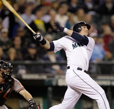 Seattle Mariners' Justin Smoak hits a 3-run home run as Baltimore Orioles catcher Matt Wieters looks on in the eighth inning of a  game played Tuesday, May 31, 2011, in Seattle. (Elaine Thompson / Associated Press)