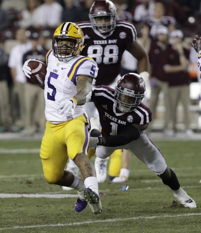 LSU running back Derrius Guice breaks away from Texas A&M defensive back Nick Harvey as he runs for a touchdown during the first quarter Thursday in College Station, Texas. (David J. Phillip / Associated Press)