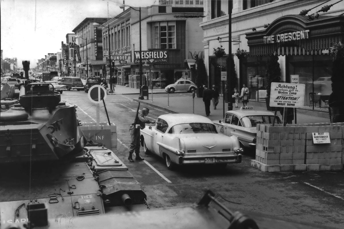 1962: Motorists on Main Avenue between Wall and Post streets in Spokane had to go through this mock checkpoint between May 9 and May 11, 1962. The faux “Berlin Wall” was put up constructed by the Spokane Advertising and Sales Association showing the importance of capitalism and free exchange. National Guardsmen at the wall handed out cards explaining the project. On Friday evening, the stack of blocks was symbolically rammed by one of the National Guard tanks.  (THE SPOKESMAN-REVIEW PHOTO ARCHIVE)