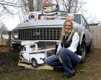 
Jennifer Blakely poses in her yard next to her husband's Suburban with some of her digital photographs that she prints, colorizes and stretches onto canvas. The large picture of the old abandoned truck was taken on her grandmother's property in southwest Oregon. 
 (J. BART RAYNIAK photos / The Spokesman-Review)