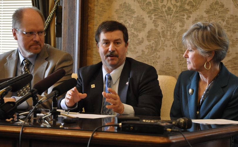 OLYMPIA-- Sen. Mark Schoesler, center, discusses what's ahead for the final day of the Legislature at a press conference with Rep. Dan Kristiansen and Sen. Linda Evans Parlette. (Jim Camden)