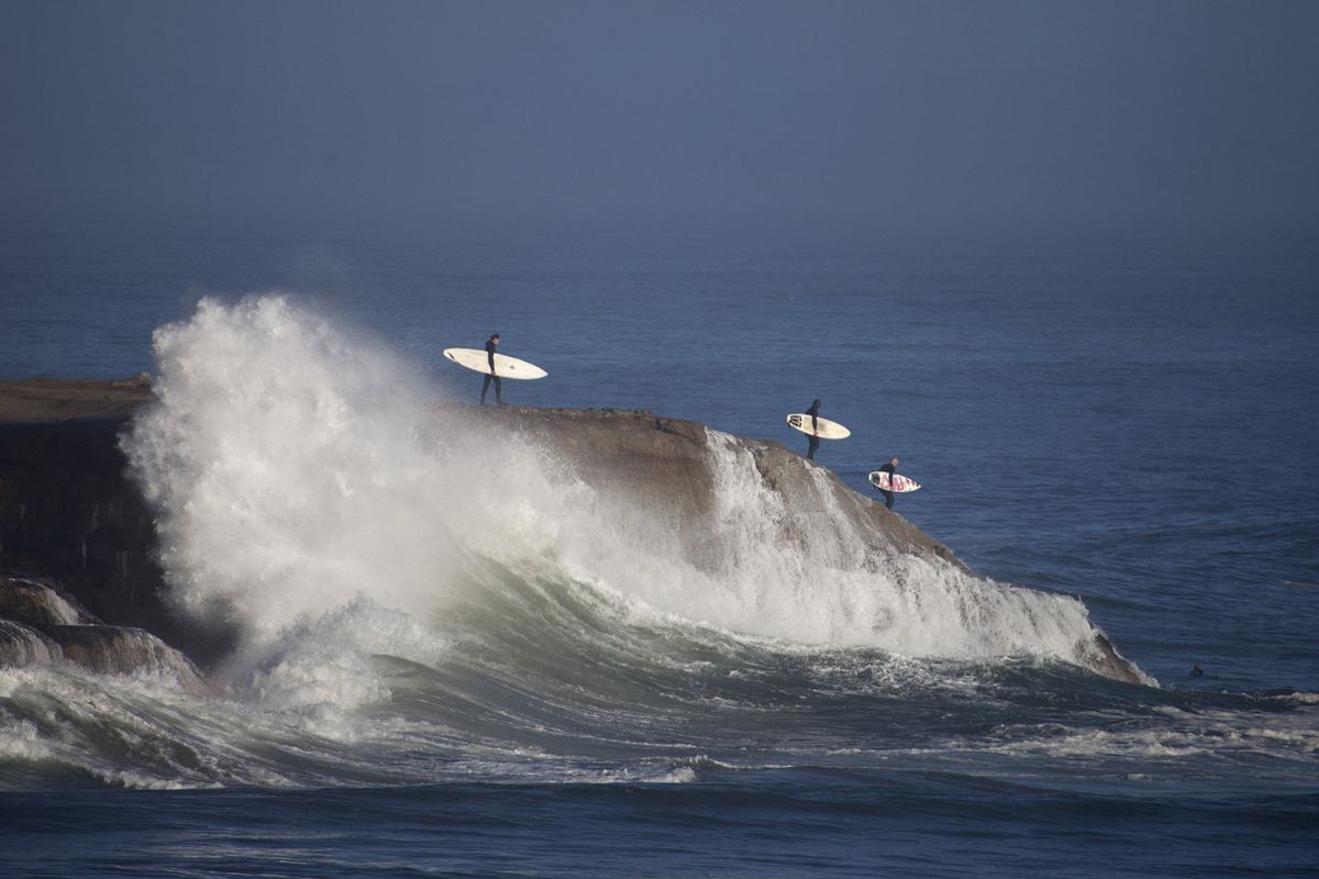 Surfers head out to catch the waves at Steamer Lane in Santa Cruz.