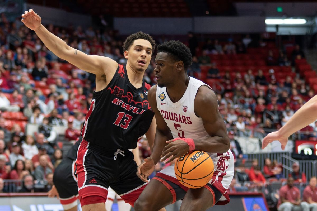 Eastern Washington forward Angelo Allegri, left, puts pressure on Washington State guard TJ Bamba in the first half of an NIT playoff game on Tuesday at Beasley Coliseum in Pullman, Wash.  (Geoff Crimmins/FOR THE SPOKESMAN)