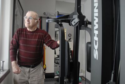 Steve Charchan stands next to equipment at Caribou Physical Therapy in Sandpoint, where he receives care for a  degenerative joint disease. Charchan inherited some money and created Heavenly Helping Hands, a scholarship fund  that supports students going into physical or occupational therapy.  (Jesse Tinsley / The Spokesman-Review)