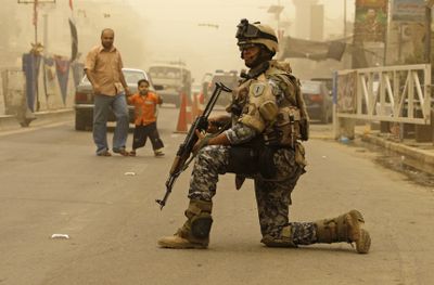 An Iraqi army soldier stands guard Sunday in central Baghdad.  (Associated Press / The Spokesman-Review)
