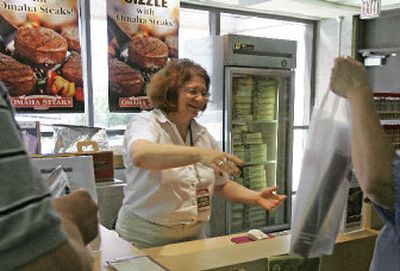 
Robbi Pozzi sells steaks at the Omaha Steaks counter at Eppley Airfield in Omaha, Neb. New restrictions put in place after an alleged plot to blow up U.S.-bound planes using liquid explosives forbid bringing aboard cold gel packs to keep the steaks frozen, so Omaha Steaks started offering free shipping, or a free cooler pack if customers buy $50 worth of steaks. 
 (Associated Press / The Spokesman-Review)