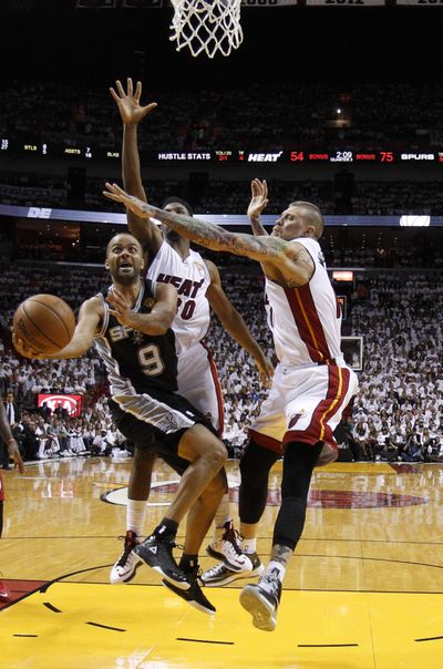 San Antonio Spurs guard Tony Parker drives as Miami Heat forward Chris Andersen, right, and guard Norris Cole defend. (Associated Press)