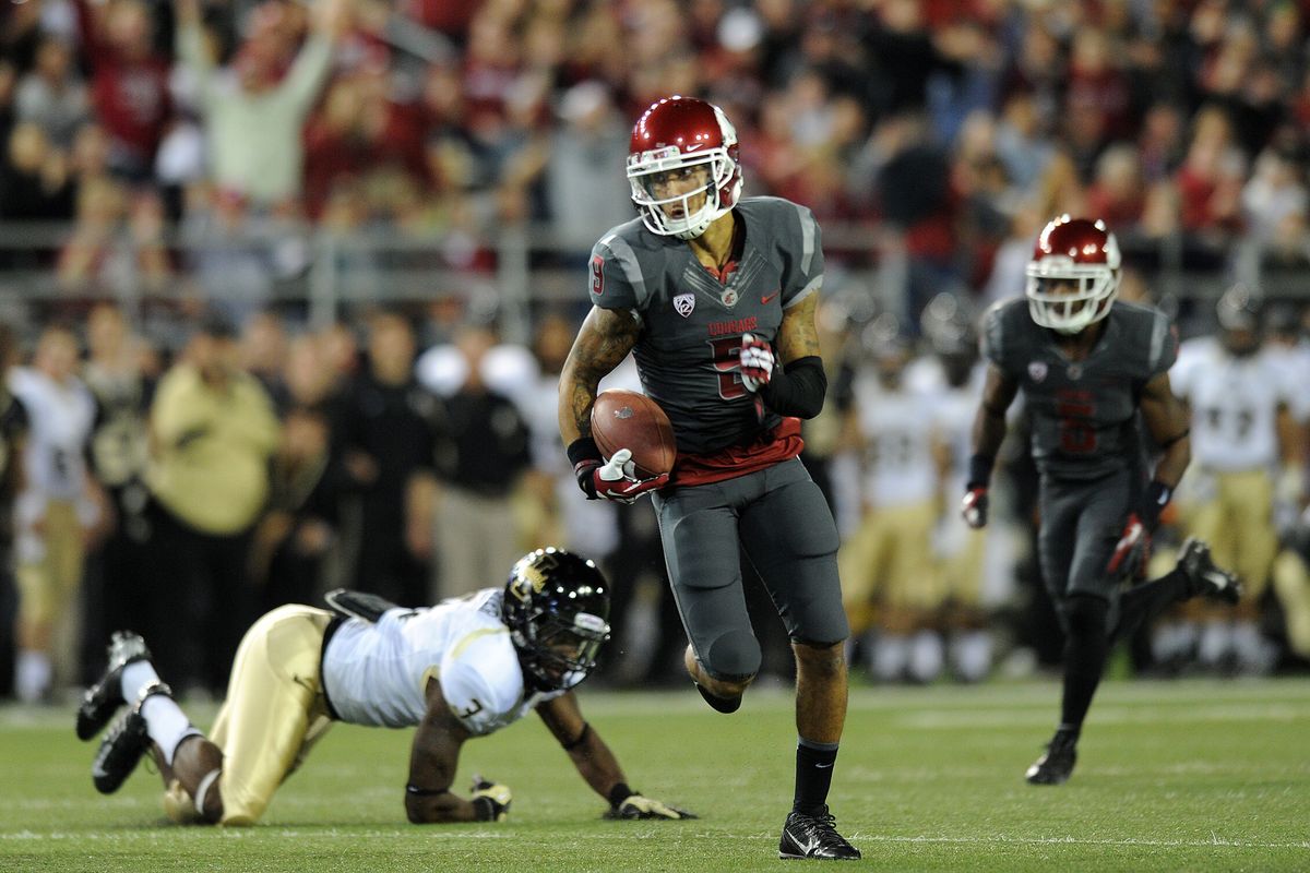 Washington State receiver Gabe Marks slips a tackle and runs for the game’s first touchdown against Idaho on Saturday. (Tyler Tjomsland photos)