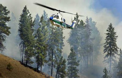 
 Cobra helicopter hovers at the Marshall fire southwest of Spokane on Aug. 11. The helicopters attack blazes before they grow past 10 acres.
 (Christopher Anderson / The Spokesman-Review)
