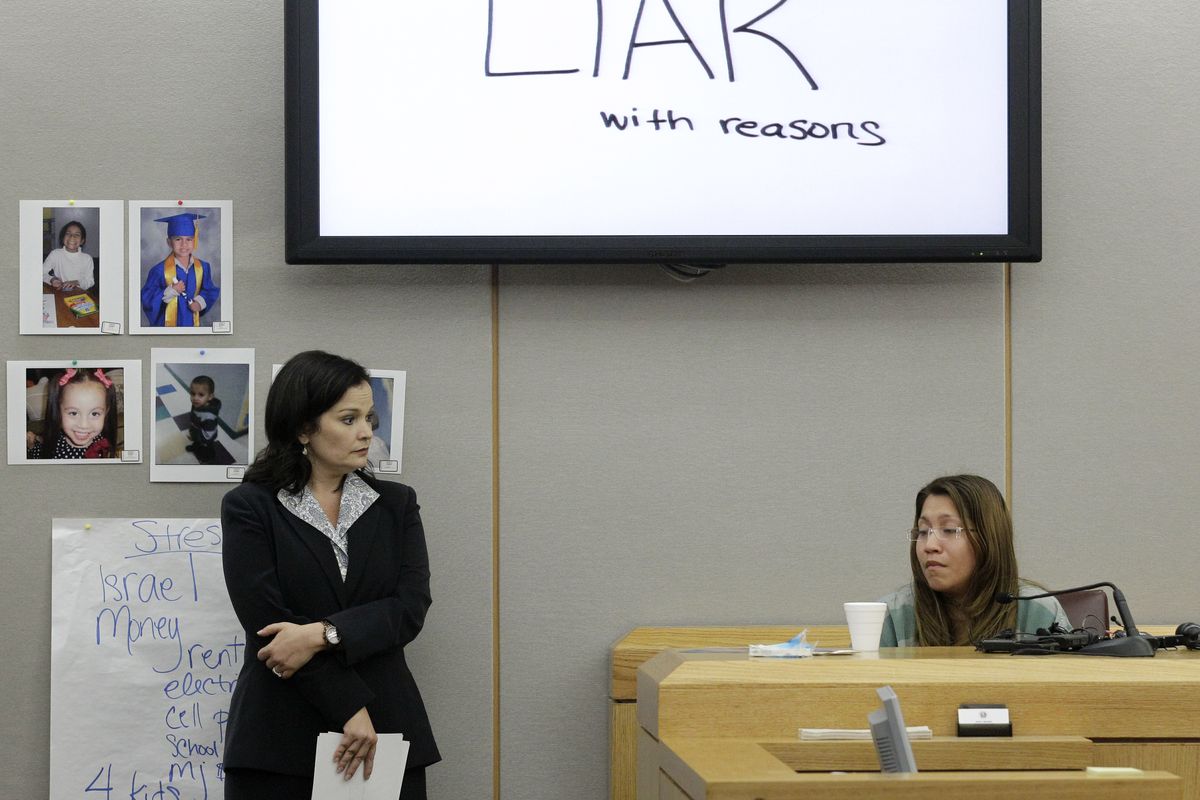 The words shown on a overhead display written by prosecutor Eren Price, left, are shown in court as an emotional Elizabeth Escalona, 23, responds to a line of questioning during the sentencing phase of her trial Thursday, Oct. 11, 2012, in Dallas. Escalona, a young mother of five who admitted beating her toddler and gluing her hands to a wall, faces anywhere from probation to life in prison. (Tony Gutierrez / Associated Press)