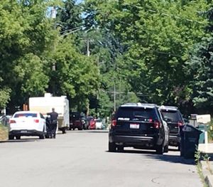 Coeur d'Alene police stage outside a N10th Place residence earlier today after being called to the scene to investigate a possible domestic dispute. (Adam Mayer/KHQ photo)