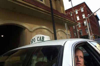 
Spokane Cab driver Daryl Dahlen waits for a fare Tuesday outside the Davenport Hotel. Dahlen said he understands the need to keep drug users out of the driver's seat, but 