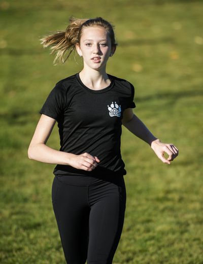 Katie Thronson, a Lewis and Clark sophomore standout in cross country, finished 17th at state as a freshman. Last December she noticed pain when running. After seeing a specialist, Thronson was told the only way she'd be able to run again was to re-train herself because her running form was not serving her well. (Colin Mulvany / The Spokesman-Review)