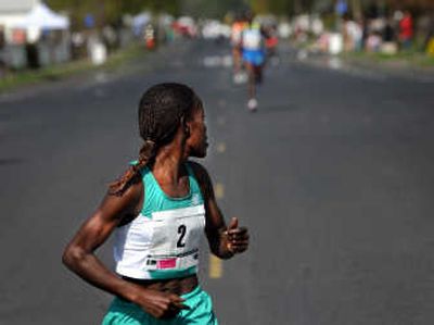 
Elite women's winner Lineth Chepkurui looks back at the competition Sunday.
 (Rajah Bose / The Spokesman-Review)