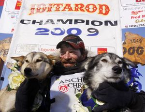 Iditarod winner Lance Mackey sits with his lead dogs Larry, right, and Maple after reaching the finish in Nome, Alaska, on Wednesday.  (Associated Press / The Spokesman-Review)