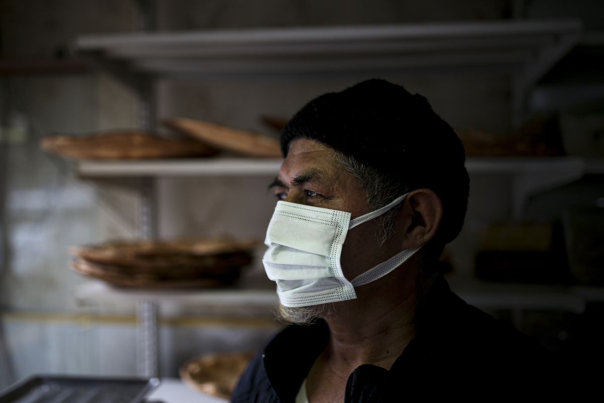 Muhammed Emin, a member of the Uighur community, looks outside in his bakery in Istanbul