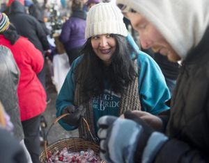 Jessica Kovac, founder of Blessings Under the Bridge, hands out candy to families in need as they wait for a Christmas dinner on Saturday, Dec. 17, 2016. Blessings has told the city of Spokane it’s not moving anywhere, after the city in May gave the nonprofit 120 days to find a new location. (Tyler Tjomsland / The Spokesman-Review)