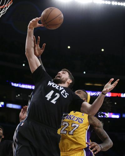 Minnesota’s Kevin Love snags a rebound over the Lakers’ Jordan Hill. (Associated Press)