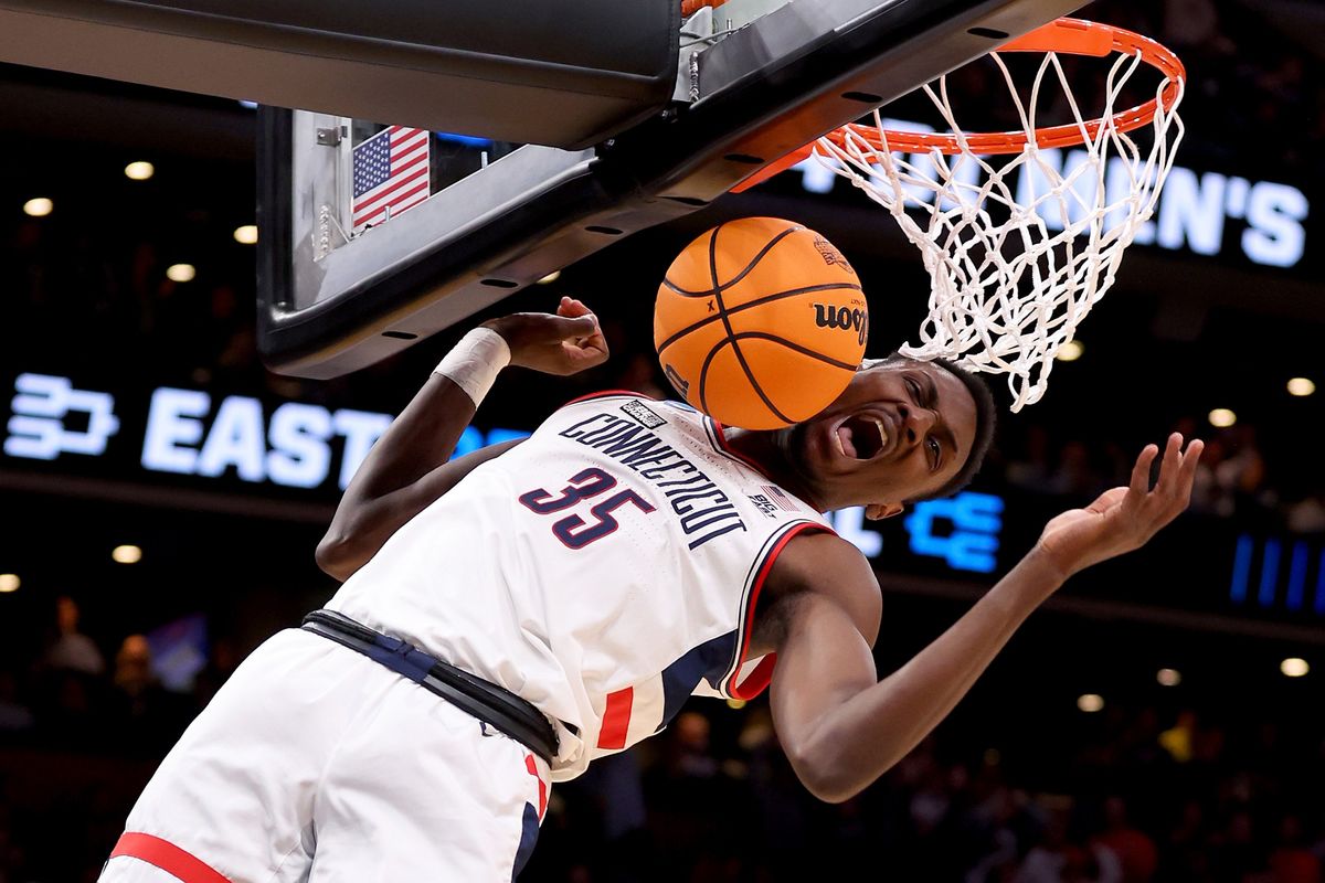 Connecticut’s Samson Johnson revels in a first-half dunk against Illinois in the Elite Eight round of the NCAA Tournament at TD Garden on Saturday in Boston.  (Tribune News Service)