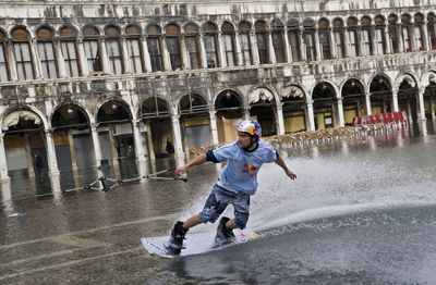 Duncan Zuur of the Netherlands rides on a wakeboard through  flooded St. Marks Square in Venice, Italy, on Tuesday.  (Associated Press / The Spokesman-Review)