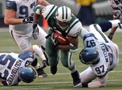 Jets running back Curtis Martin bowls over Seahawks Niko Koutouvides, left, and Brandon Mitchell on a fourth-quarter run on Sunday in East Rutherford, N.J.
 (Associated Press / The Spokesman-Review)
