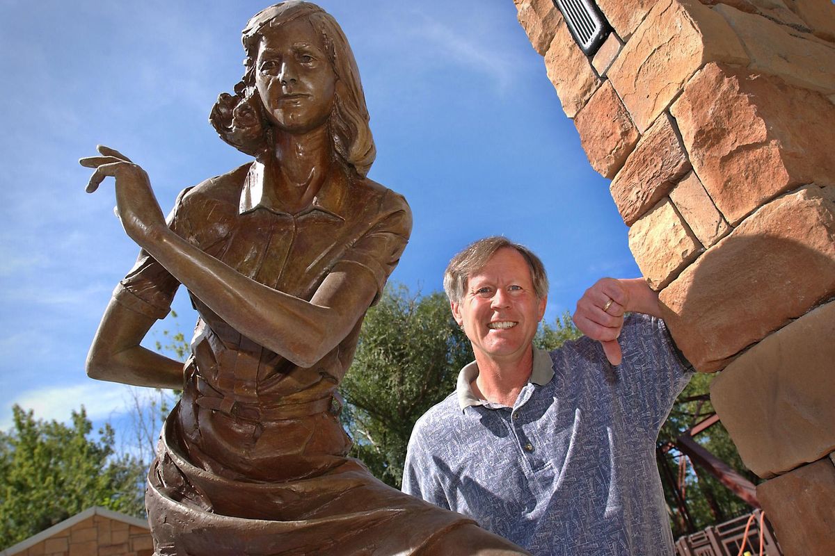 FILE – Les Bock, of the Idaho Human Rights Education Center, stands next to a bronze statue of Anne Frank in the new Anne Frank Human Rights Memorial in Boise on Aug. 13, 2002. (TROY MABEN / AP)