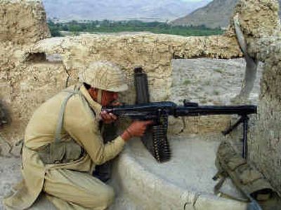 
A Pakistani soldier aims his machine gun near Afghanistan on Monday. 
 (Associated Press / The Spokesman-Review)