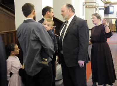 
Clifford Helm talks with members of the Mennonite community during a break in Wednesday's court proceedings. 
 (Dan Pelle / The Spokesman-Review)