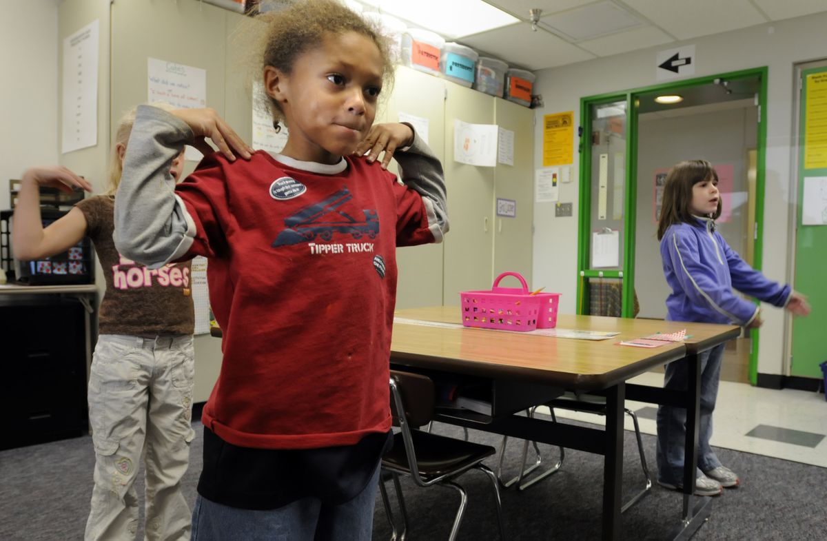 First-grader Donovan White, center, dances to a song about the alphabet in first grade at Regal Elementary in Spokane Thursday. White is part of the first class of students  who had all-day kindergarten in Spokane last year. At far right is Nicole Resonovic. (Jesse Tinsley / The Spokesman-Review)