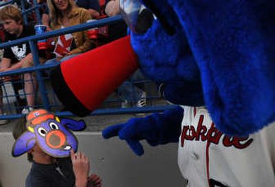 
Dilan Kohn compares faces with Otto the Spokane Indians mascot during a game at Avista Field.
 (Rajah Bose / The Spokesman-Review)