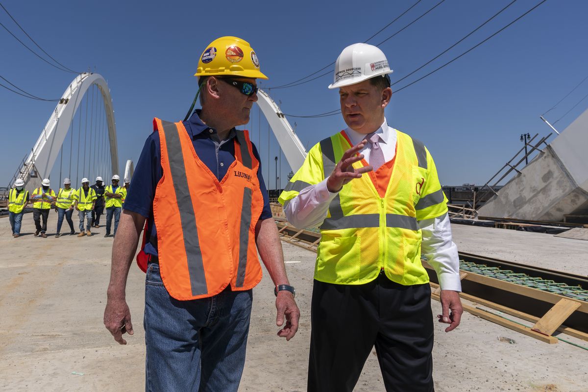 Secretary of Labor Marty Walsh, right, visits the Frederick Douglass Memorial Bridge construction site together with District of Columbia Mayor Muriel Bowser and Secretary of Transportation Pete Buttigieg on May 19 in southeast Washington.  (Manuel Balce Ceneta)