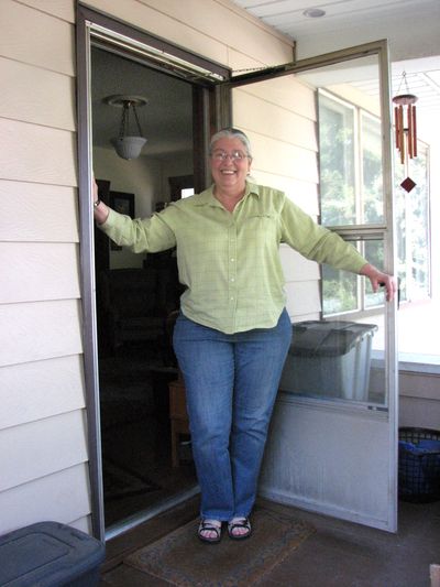 Homeowner Lea Smith stands in the doorway to her newly energy retrofitted home in the South Perry neighborhood. (Pia Hallenberg)