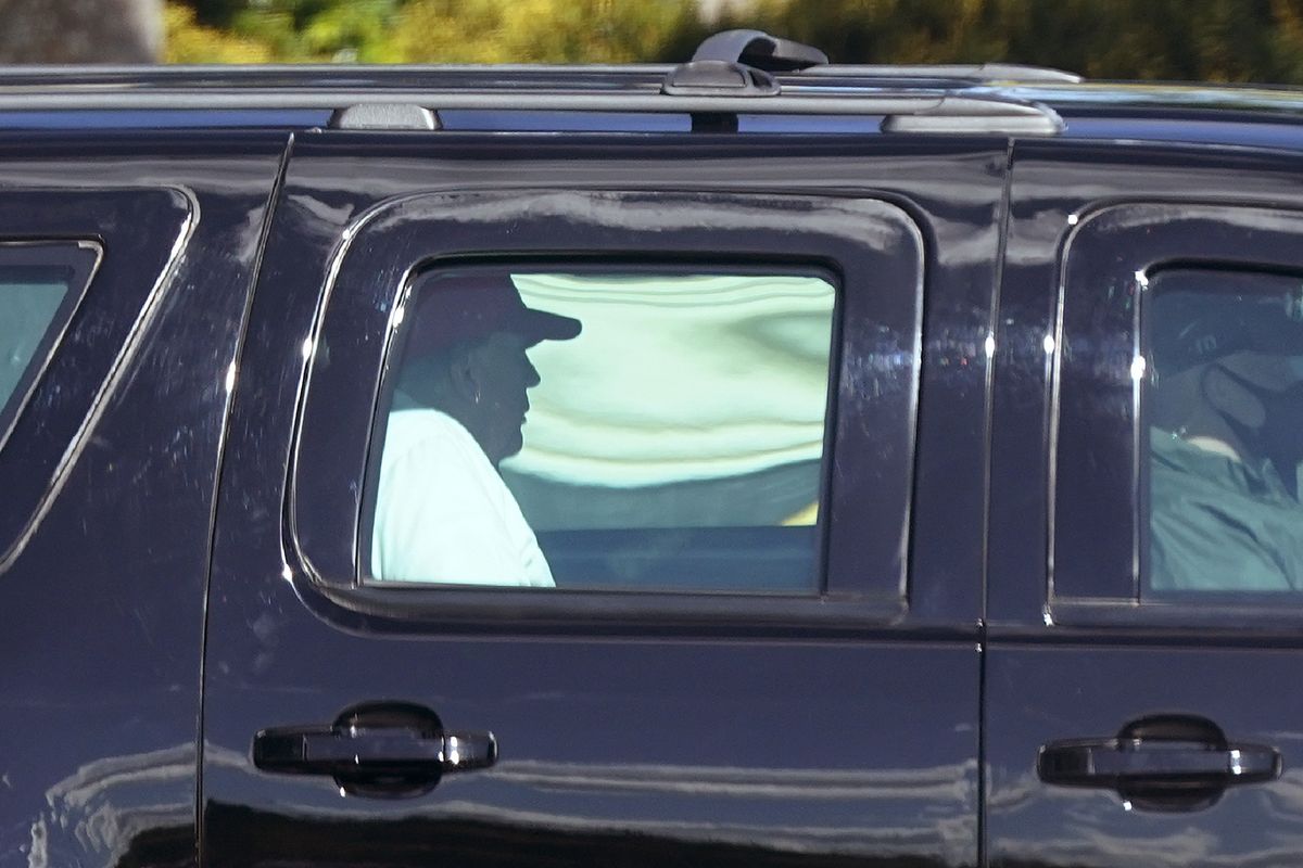 President Donald Trump rides in a motorcade vehicle as he departs Trump International Golf Club, Sunday, Dec. 27, 2020, in West Palm Beach, Fla.  (Patrick Semansky)